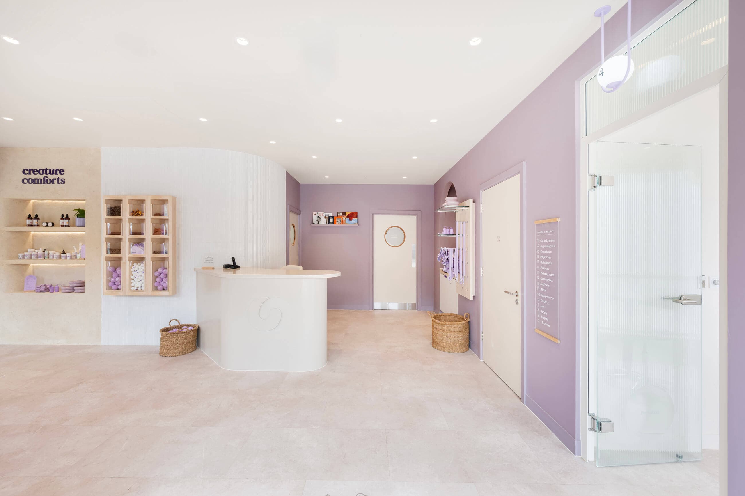 A serene interior of our reception area with soft purple walls, modern decor, and shelves displaying pet treats.