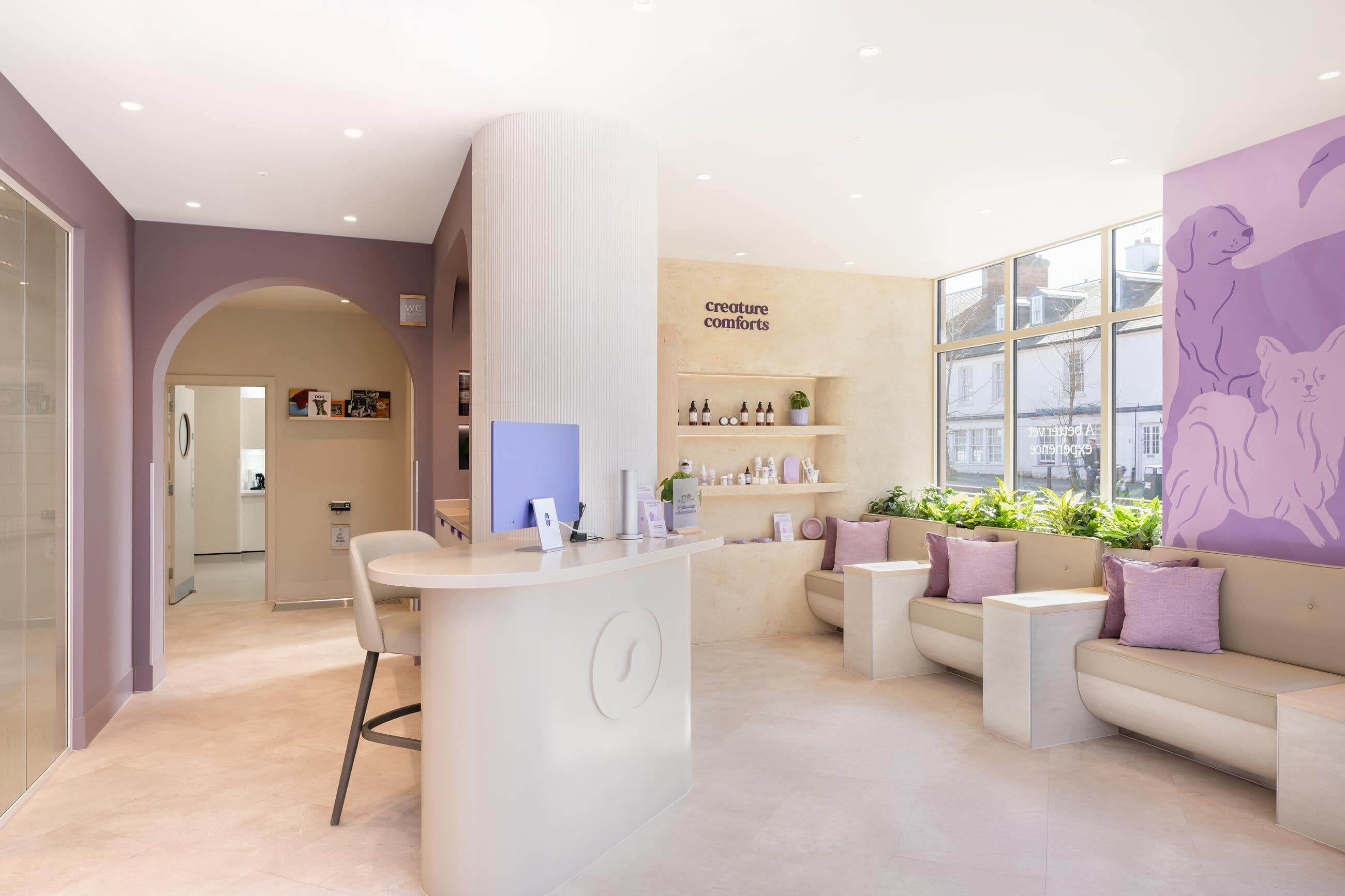 Bright and inviting animal clinic reception with modern decor, welcoming seating, and a display of pet care products.